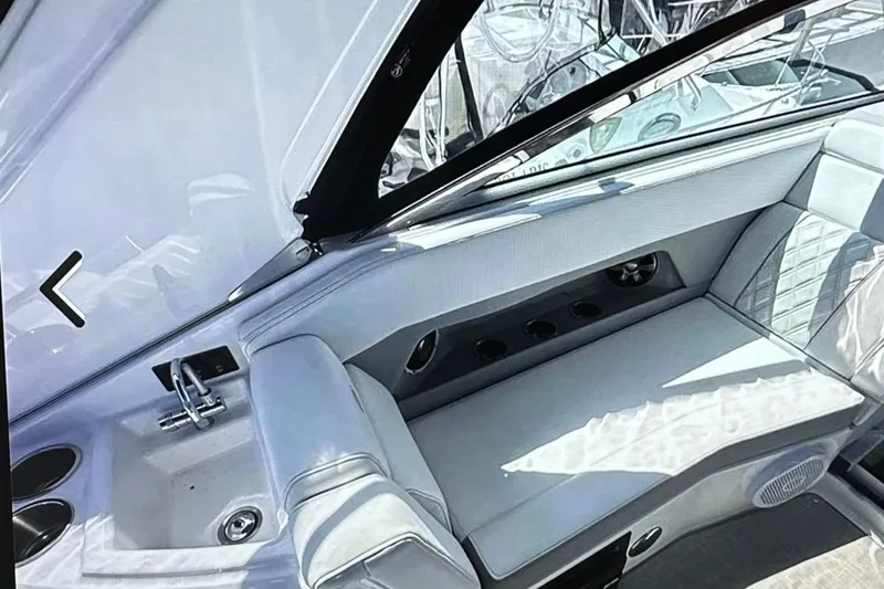 Slide: The Image of 2022 Regal 28 Express boat interior with seating and sink, showcasing luxury design. - 10