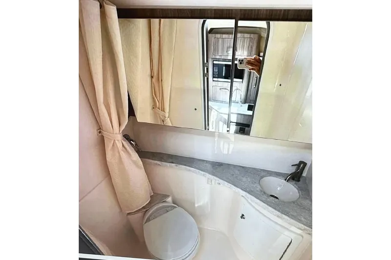Slide: The Image of Bathroom interior of 2022 Regal 28 Express boat with mirror and sink. - 16