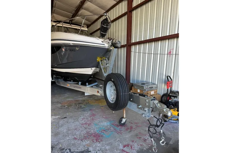 Slide: The Image of 2022 Regal 28 Express boat on trailer in storage facility. - 21