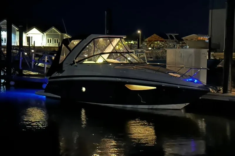 Slide: The Image of 2022 Regal 28 Express boat docked at night with ambient lighting. - 5