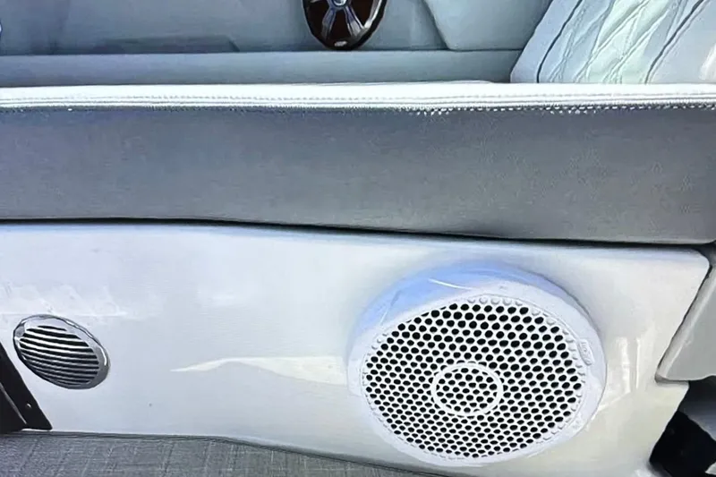 Slide: The Image of 2022 Regal 28 Express boat interior with speaker and cushioned seating. - 7