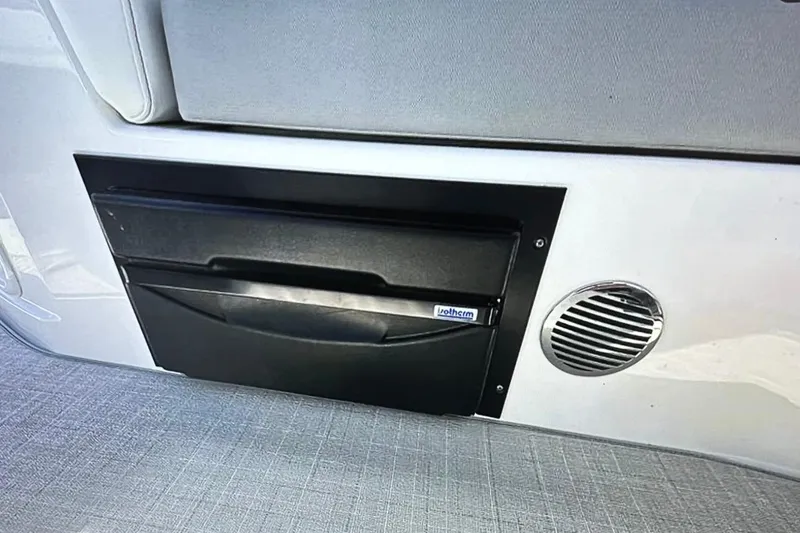 Slide: The Image of 2022 Regal 28 Express interior detail with storage compartment and speaker. - 8