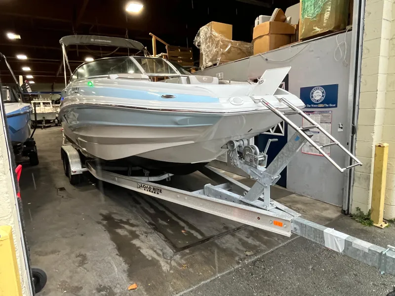Slide: The Image of 2023 Crownline Eclipse E235 XS boat on trailer in indoor storage. - 12