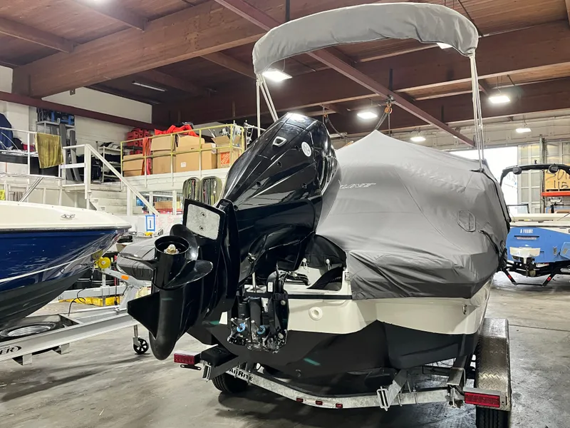 Slide: The Image of 2023 Crownline Eclipse E235 XS boat covered in a garage setting. - 3