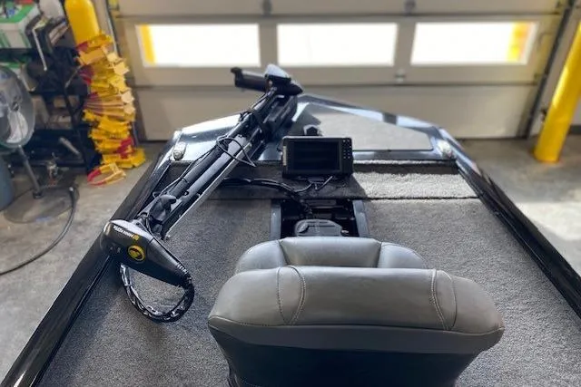 Slide: The Image of 2025 Tracker Pro 170 boat in a workshop, featuring sleek design and trailer. - 2