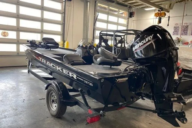 Slide: The Image of 2025 Tracker Pro 170 boat with Mercury engine in a garage setting. - 5