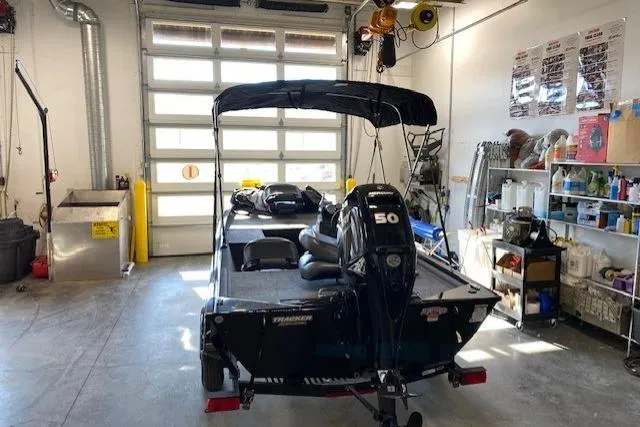 Slide: The Image of 2025 Tracker Pro 170 boat in garage, equipped with a 50 HP motor. - 6