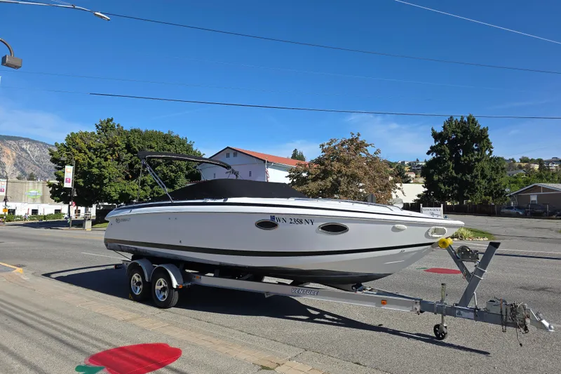 The Image of 2001 Cobalt 263 boat on trailer in urban setting, clear blue sky. - 0