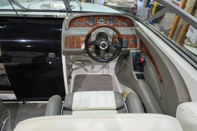 Slide: The Image of Interior of a 2001 Cobalt 263 boat, featuring a sleek dashboard and steering wheel. - 11