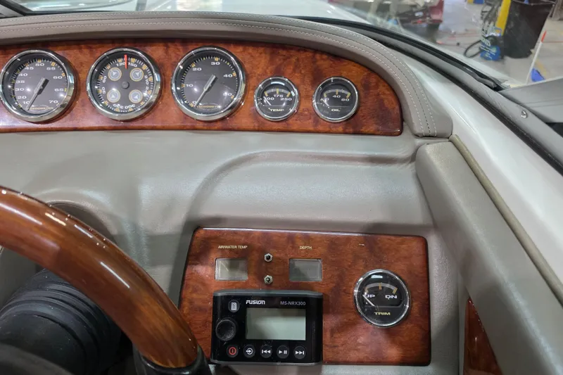 Slide: The Image of Dashboard of a 2001 Cobalt 263 boat with wood accents and gauges. - 13