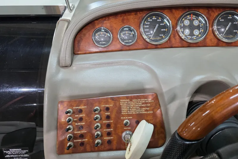 Slide: The Image of Dashboard of a 2001 Cobalt 263 boat with gauges and control switches. - 14
