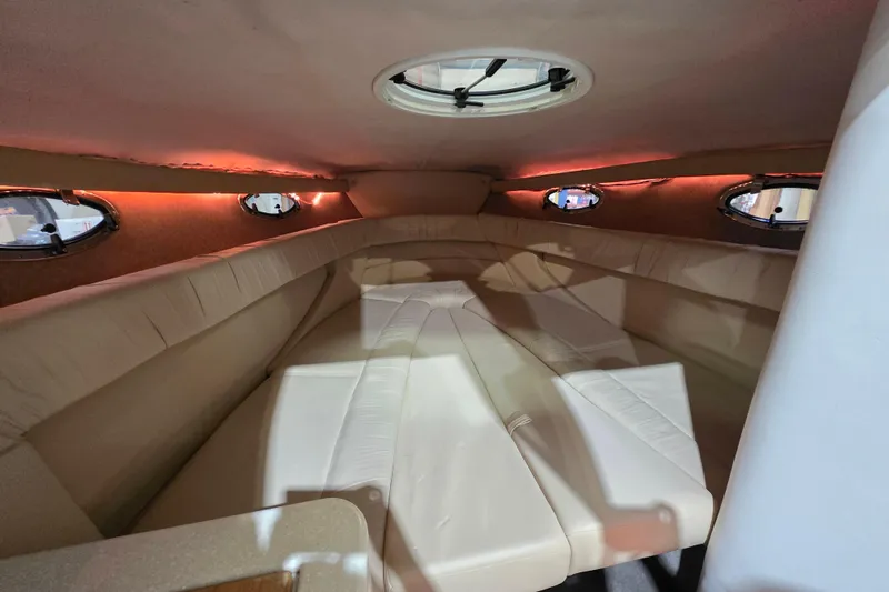 Slide: The Image of Interior cabin of a 2001 Cobalt 263 boat with beige seating and ambient lighting. - 15