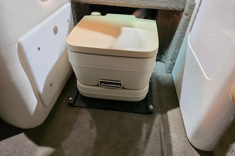 Slide: The Image of Portable toilet inside a 2001 Cobalt 263 boat cabin, featuring a compact design. - 17