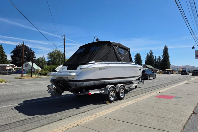 Slide: The Image of Cobalt 263 boat on trailer, parked on roadside, clear blue sky, 2001 model. - 4