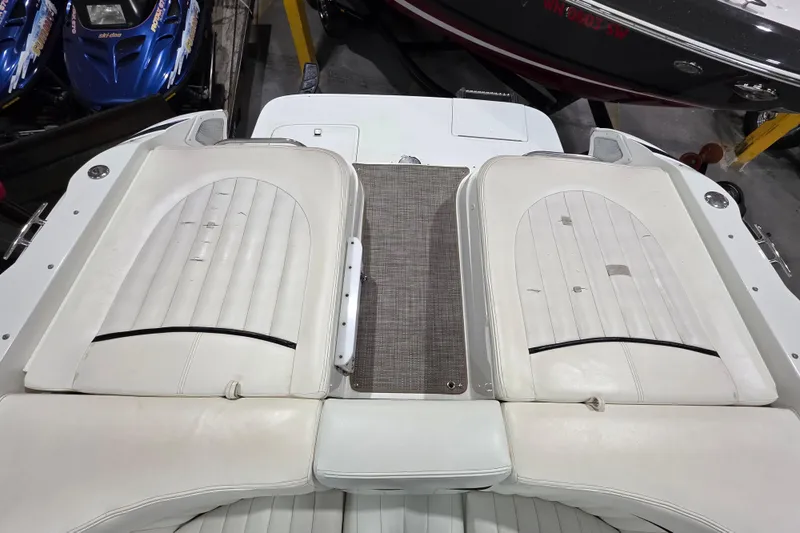 Slide: The Image of 2001 Cobalt 263 boat interior with white cushioned seating and storage area. - 5