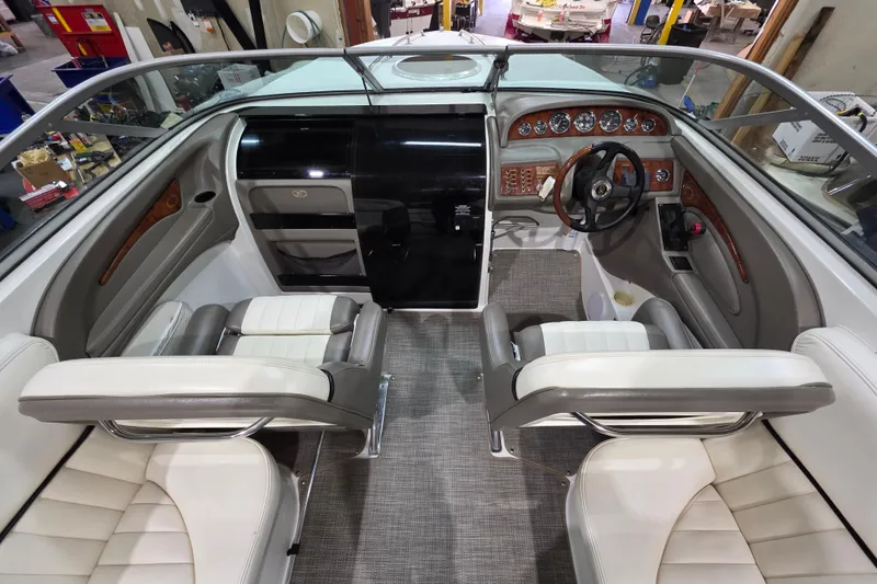 Slide: The Image of Interior of a 2001 Cobalt 263 boat with leather seating and wood-accented dashboard. - 9