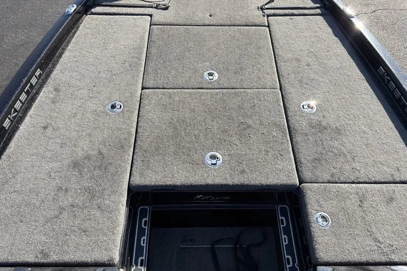 Slide: The Image of 2015 Skeeter FX20 boat deck with storage compartments and carpeted surface. - 11
