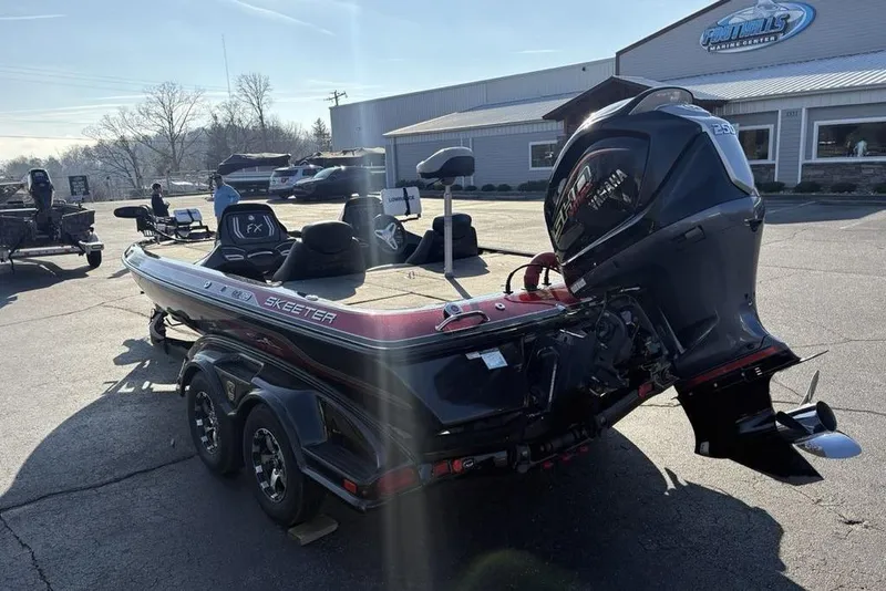 Slide: The Image of 2015 Skeeter FX20 boat with powerful outboard motor in a marine center parking lot. - 12