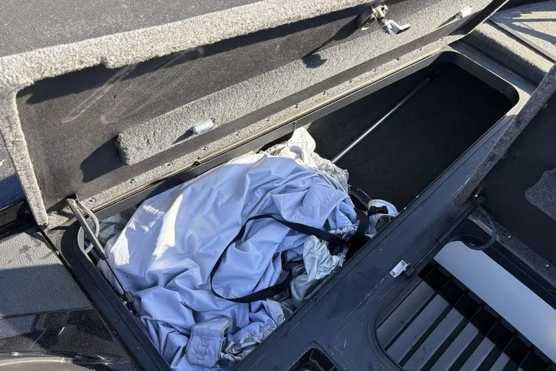 Slide: The Image of Open storage compartment in 2015 Skeeter FX20 boat with cover inside. - 13