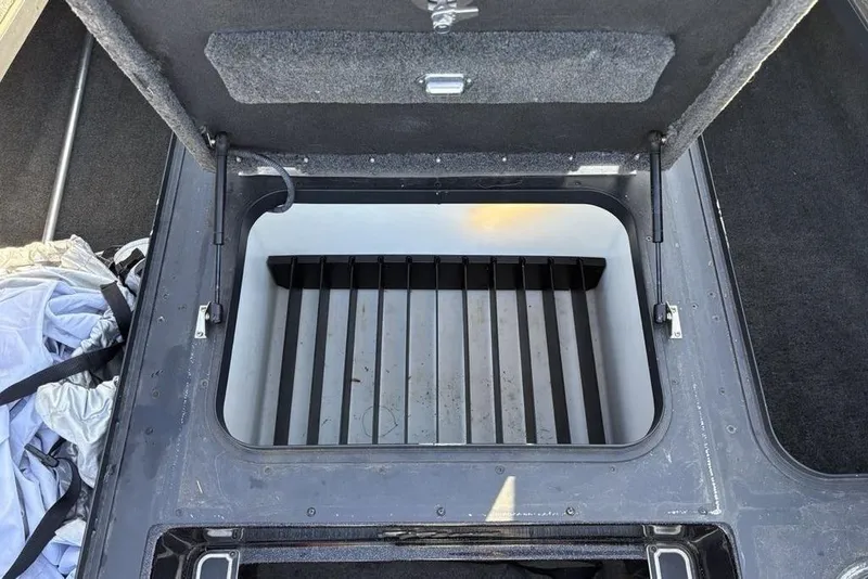 Slide: The Image of Open storage compartment in a 2015 Skeeter FX20 boat, showing interior details. - 14