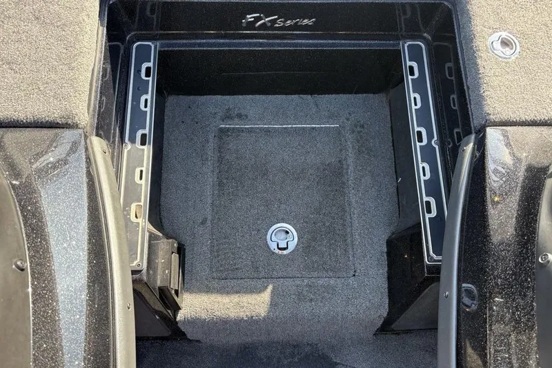 Slide: The Image of 2015 Skeeter FX20 boat storage compartment with carpeted interior and secure latch. - 17