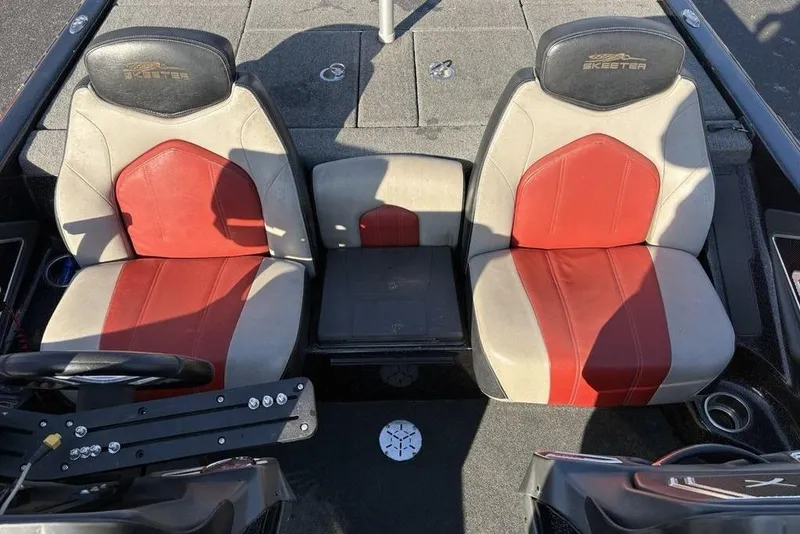 Slide: The Image of 2015 Skeeter FX20 boat interior with red and beige seats, steering wheel, and console. - 22