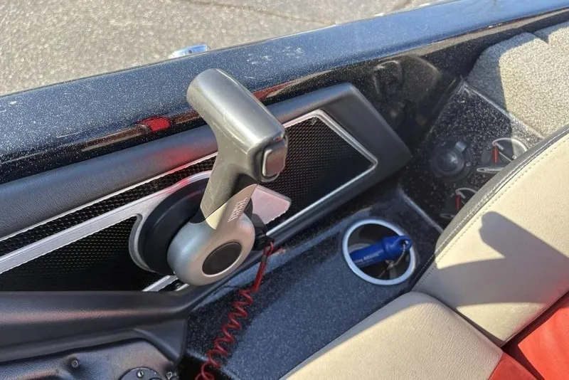 Slide: The Image of 2015 Skeeter FX20 boat interior with throttle control and cup holder. - 26