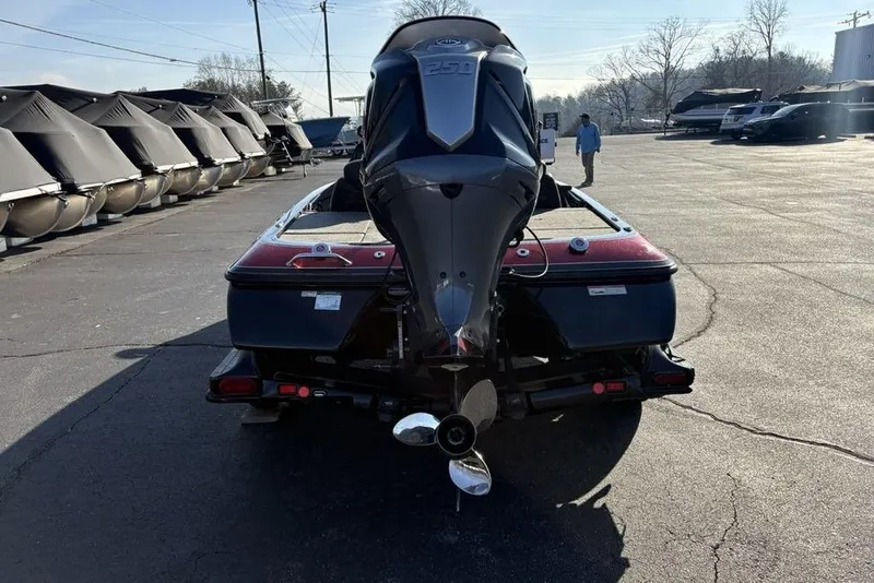 Slide: The Image of 2015 Skeeter FX20 boat with powerful outboard motor in a marina parking lot. - 3