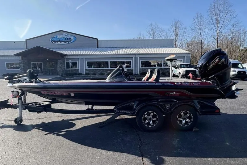Slide: The Image of 2015 Skeeter FX20 bass boat parked outside a marine center. - 4
