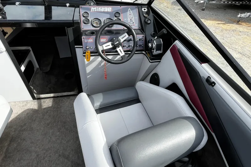 Slide: The Image of 1988 Mirage Manufacturing 217 Intruder boat interior with steering wheel and control panel. - 11