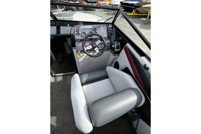 Slide: The Image of 1988 Mirage Manufacturing 217 Intruder boat cockpit with steering wheel and controls. - 12