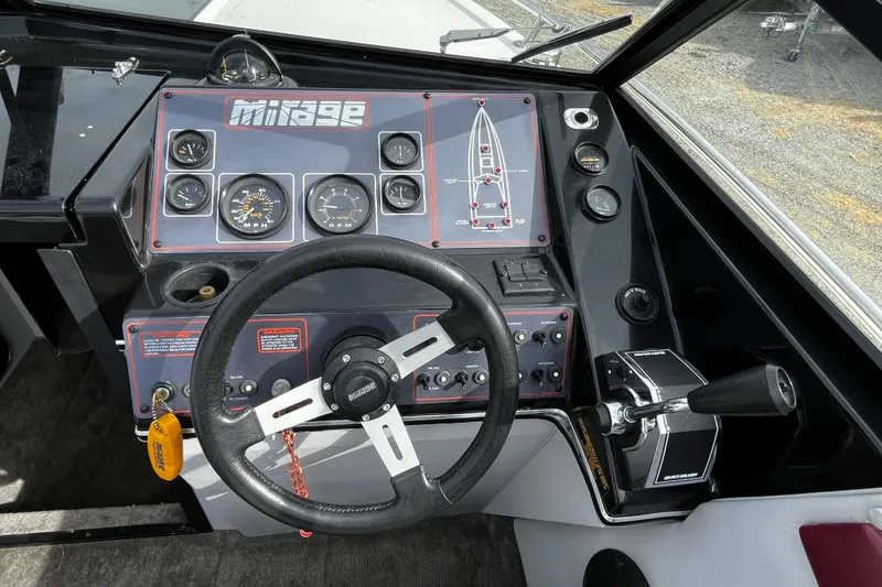 Slide: The Image of 1988 Mirage Manufacturing 217 Intruder boat dashboard with steering wheel and control panel. - 13