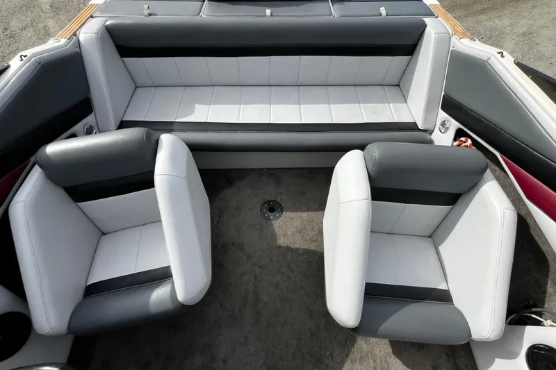 Slide: The Image of Interior of a 1988 Mirage 217 Intruder boat with gray and white seating. - 16