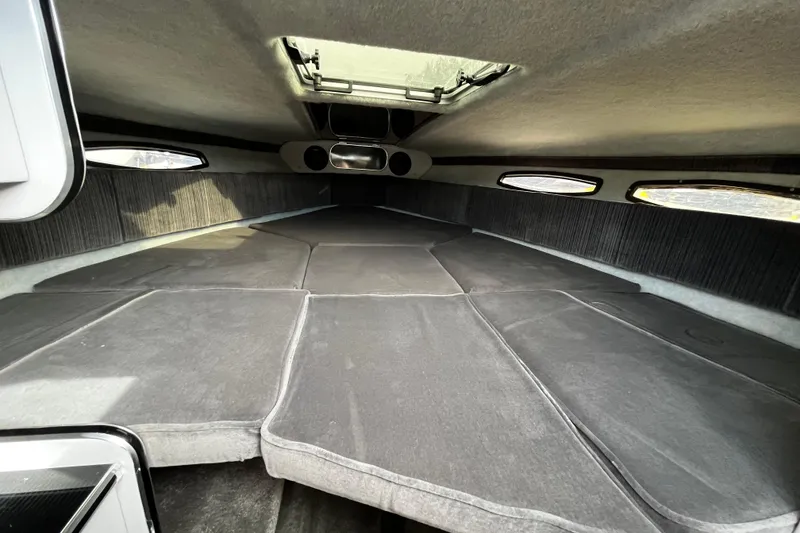 Slide: The Image of Interior cabin of 1988 Mirage Manufacturing 217 Intruder boat with cushioned seating and windows. - 18