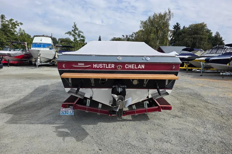 Slide: The Image of 1988 Mirage Manufacturing 217 Intruder boat, rear view, parked on gravel lot. - 2