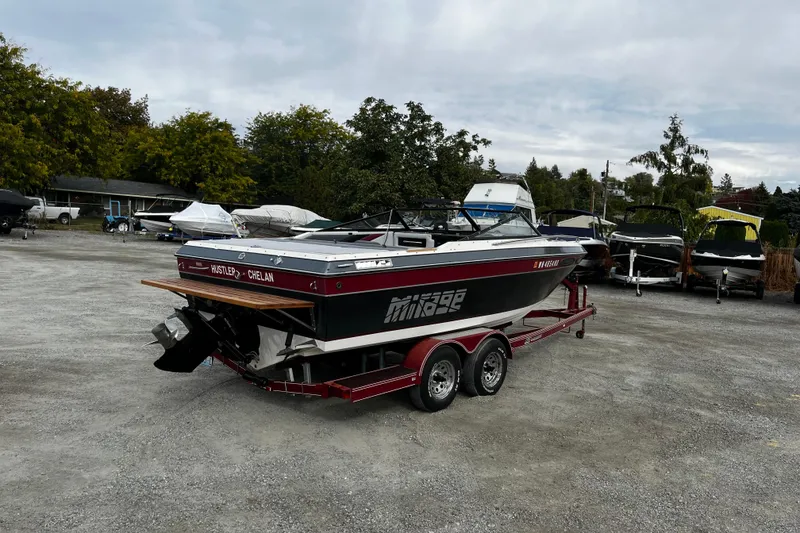 Slide: The Image of 1988 Mirage Manufacturing 217 Intruder boat on trailer in outdoor storage area. - 4