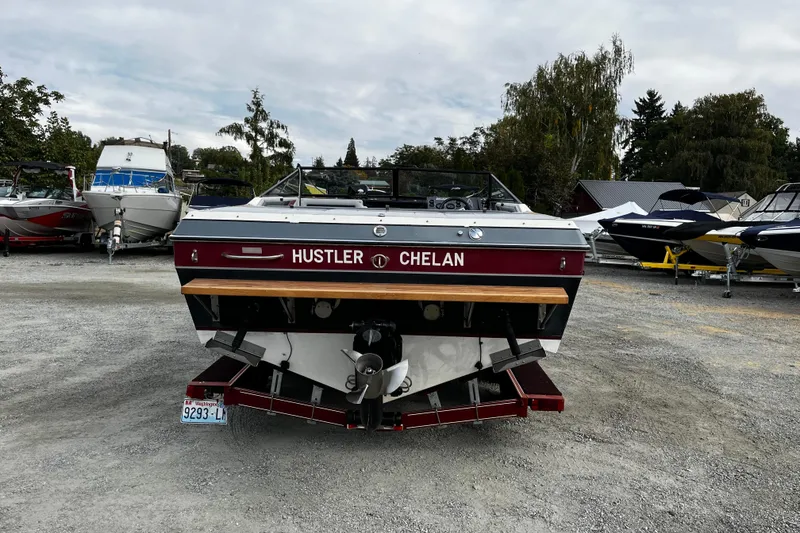 Slide: The Image of 1988 Mirage Manufacturing 217 Intruder boat in a marina, rear view. - 5