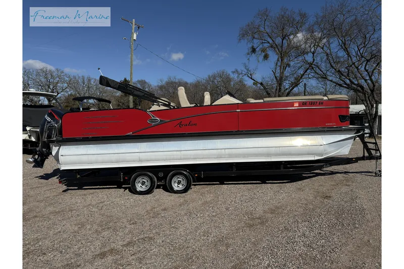 Slide: The Image of 2019 Avalon Catalina Quad Lounge 25' pontoon boat on trailer, red exterior, sunny day. - 1