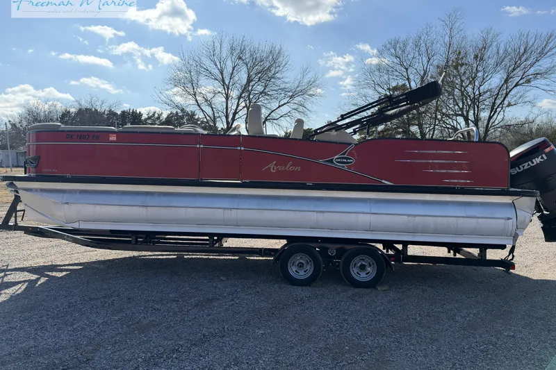 Slide: The Image of 2019 Avalon Catalina Quad Lounge 25' pontoon boat on trailer, red exterior. - 12