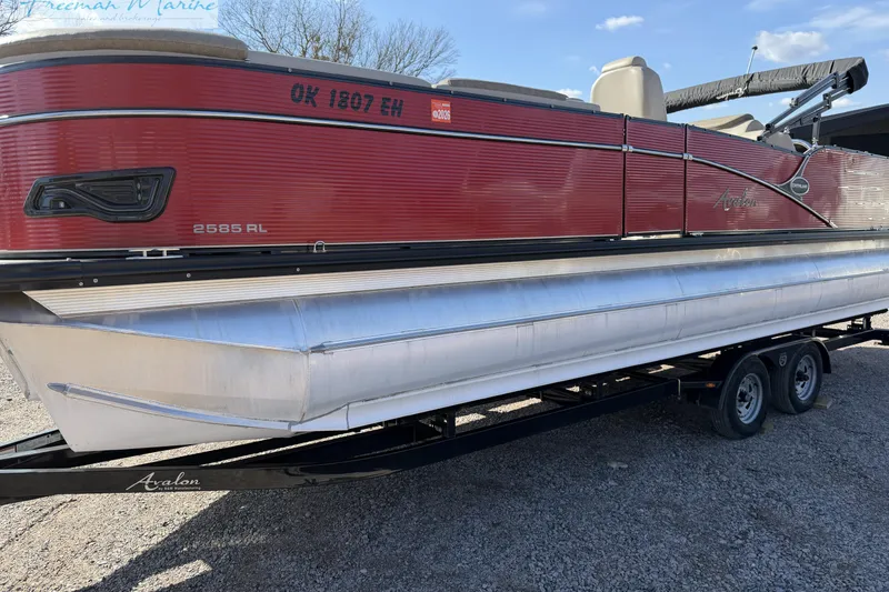 Slide: The Image of 2019 Avalon Catalina Quad Lounge 25' pontoon boat on trailer, red exterior. - 13