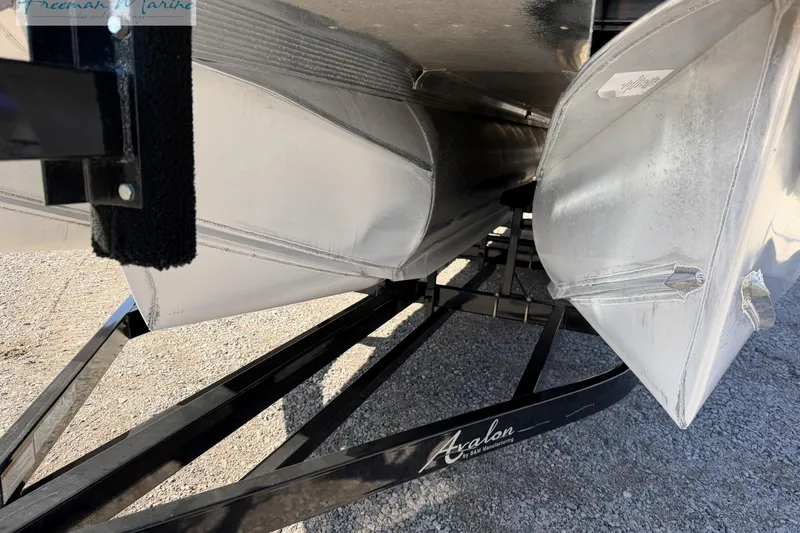 Slide: The Image of 2019 Avalon Catalina Quad Lounge 25' pontoon boat on trailer, close-up view. - 14