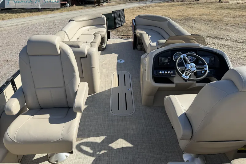Slide: The Image of 2019 Avalon Catalina Quad Lounge 25' interior with beige seating and steering console. - 17