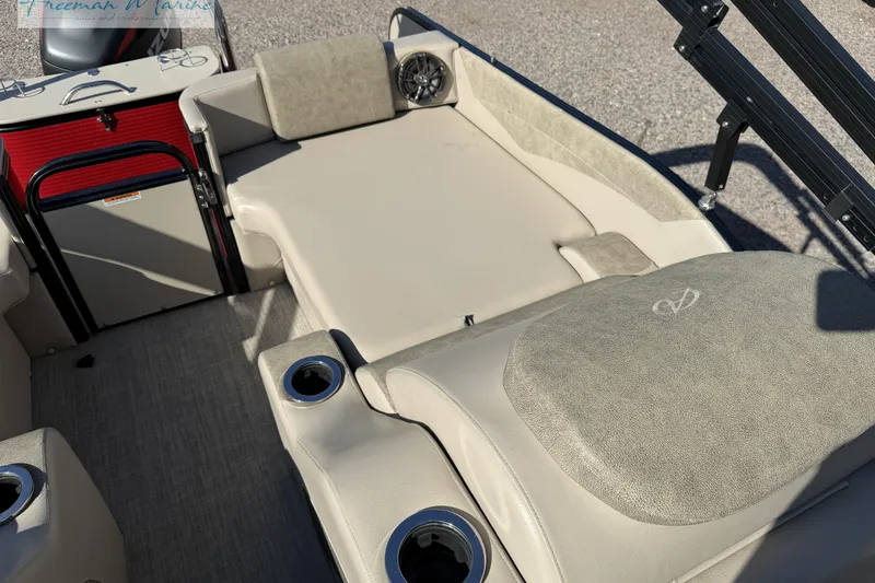 Slide: The Image of 2019 Avalon Catalina Quad Lounge boat interior with beige seating and cup holders. - 20