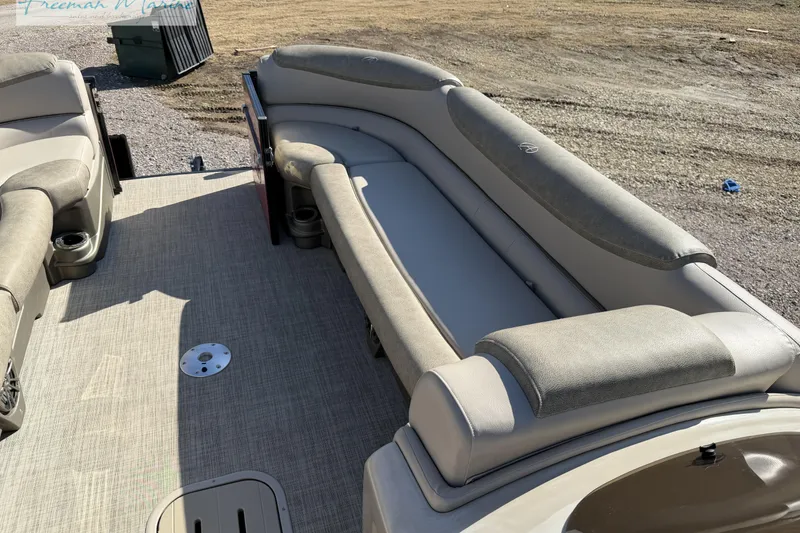 Slide: The Image of 2019 Avalon Catalina Quad Lounge 25' interior with beige seating and carpeted floor. - 22