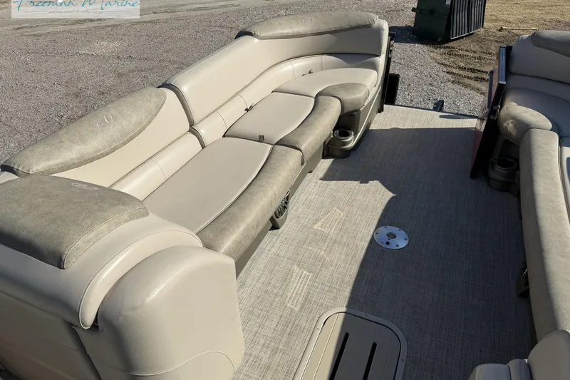 Slide: The Image of 2019 Avalon Catalina Quad Lounge 25' interior with beige seating and cup holders. - 23