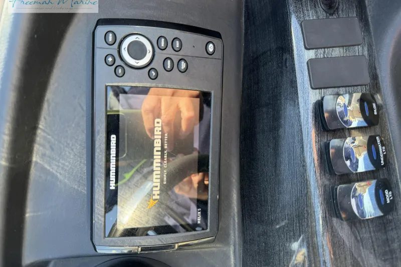 Slide: The Image of Control panel of a 2019 Avalon Catalina Quad Lounge boat with Humminbird display. - 26