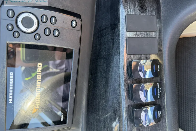 Slide: The Image of Control panel of 2019 Avalon Catalina Quad Lounge with Humminbird display and switches. - 27