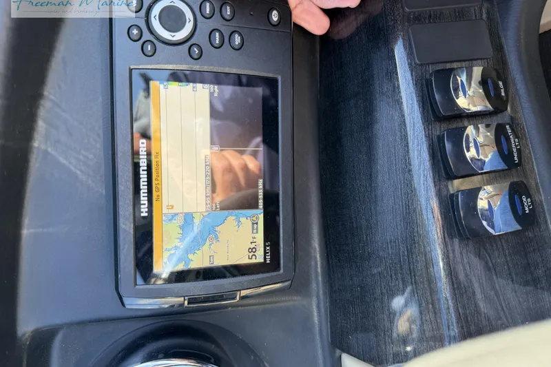 Slide: The Image of 2019 Avalon Catalina Quad Lounge dashboard with Humminbird GPS and control switches. - 29