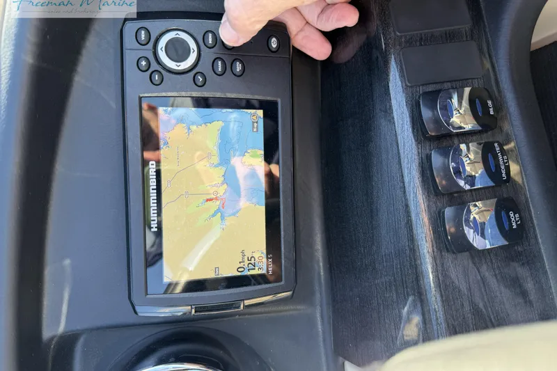 Slide: The Image of 2019 Avalon Catalina Quad Lounge dashboard with Humminbird GPS and control switches. - 31