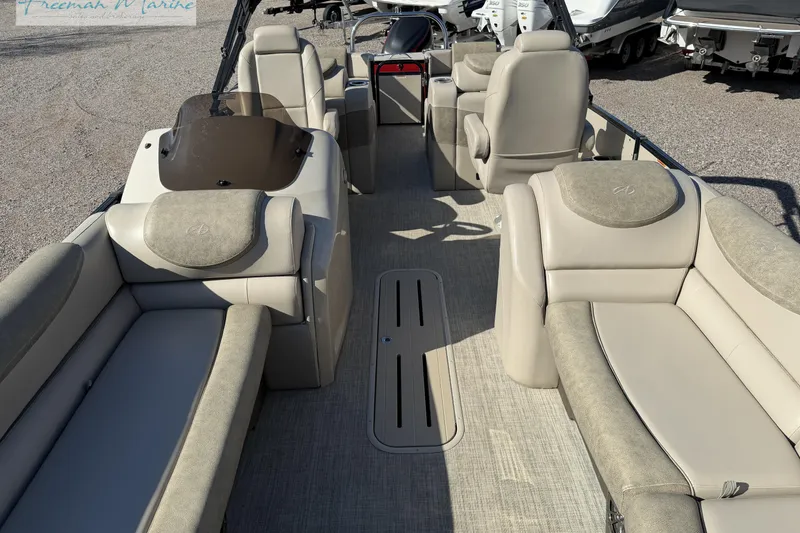 Slide: The Image of 2019 Avalon Catalina Quad Lounge 25' interior with beige seating and helm. - 32